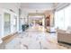 Elegant hallway with marble floors, decorative lighting, seating area, and access to a business office at 2104 Hembury Pl # 33, Sun City Center, FL 33573