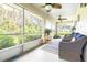 Relaxing screened porch with wicker furniture and ceiling fans at 2104 Hembury Pl # 33, Sun City Center, FL 33573