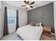 Guest bedroom with gray accent wall and ceiling fan at 11633 Mandevilla View Way, Riverview, FL 33579