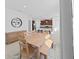 Dining area with light wood table and view into the kitchen at 11633 Mandevilla View Way, Riverview, FL 33579