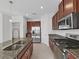 Modern kitchen with stainless steel appliances and granite countertops at 11633 Mandevilla View Way, Riverview, FL 33579