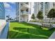 Outdoor dog park featuring artificial turf, a dog run and picnic table for residents to enjoy at 301 1St S St # 1104, St Petersburg, FL 33701