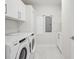 Bright laundry room with modern appliances, clean white cabinetry, and tiled floor at 301 1St S St # 1104, St Petersburg, FL 33701