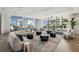 The spacious living room has floor to ceiling windows with ocean views and comfortable furniture at 301 1St S St # 1104, St Petersburg, FL 33701