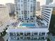 Aerial view of a rooftop pool deck with lounge chairs, umbrellas and city views at 301 1St S St # 1104, St Petersburg, FL 33701