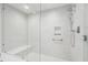 Glass enclosed shower with bench seat, shower head, and grab bar at 301 1St S St # 1104, St Petersburg, FL 33701