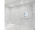 Glass enclosed shower with bench seat, shower head, grab bar, and tiled walls at 301 1St S St # 1104, St Petersburg, FL 33701