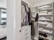 Organized walk-in closet with shelving for clothing, shoes, and folded items at 301 1St S St # 1104, St Petersburg, FL 33701