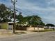 Mid-century modern home with yellow exterior and fenced yard at 304 Patty Dr, Oldsmar, FL 34677