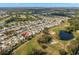 Aerial view of a residential neighborhood surrounded by lush greenery and multiple ponds at 2013 E Del Webb Blvd, Sun City Center, FL 33573