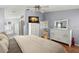 Serene main bedroom with light blue walls, wood floors, and a glimpse into the bathroom at 2013 E Del Webb Blvd, Sun City Center, FL 33573