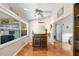 Cozy wet bar with wooden stools, storage and a large window with exterior view at 2013 E Del Webb Blvd, Sun City Center, FL 33573