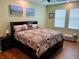 Spacious main bedroom with a king bed and wood floors at 2117 Valterra Vista Way, Valrico, FL 33594