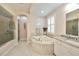 Bathroom with a large soaking tub and separate shower at 618 Islebay Dr, Apollo Beach, FL 33572