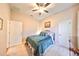 Bright bedroom with teal bedding and ceiling fan, offering a tranquil atmosphere at 618 Islebay Dr, Apollo Beach, FL 33572