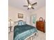 Spacious bedroom with teal bedding, ceiling fan, and ample natural light at 618 Islebay Dr, Apollo Beach, FL 33572