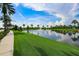 Relaxing lake view with fountain and lush green space at 618 Islebay Dr, Apollo Beach, FL 33572