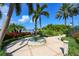 Ornate fountain in landscaped courtyard with palm trees and lake views at 618 Islebay Dr, Apollo Beach, FL 33572