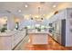 Bright kitchen with white cabinets, island, and stainless steel appliances at 618 Islebay Dr, Apollo Beach, FL 33572