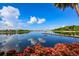 Scenic lake view with dock and lush vegetation at 618 Islebay Dr, Apollo Beach, FL 33572