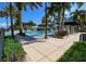 Resort-style pool with lounge chairs and palm trees at 618 Islebay Dr, Apollo Beach, FL 33572