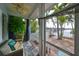 Peaceful screened porch with water views, wicker seating, and lush greenery at 618 Islebay Dr, Apollo Beach, FL 33572