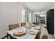 Modern dining area with a white table and view into the kitchen at 6338 8Th S Ave, Gulfport, FL 33707