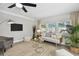 Living room with light gray sofa and large windows at 6338 8Th S Ave, Gulfport, FL 33707