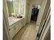 Bathroom with white vanity, mirror, and walk-in closet at 11712 Stonesmith Xing, Palmetto, FL 34221