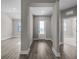 Hallway with plank flooring, neutral paint, and access to multiple rooms and the front door at 12152 Snow Bird Ave, Port Charlotte, FL 33981