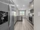 Kitchen featuring stainless steel appliances, including a refrigerator, and gray cabinets with quartz countertops at 12152 Snow Bird Ave, Port Charlotte, FL 33981