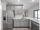 Kitchen featuring stainless steel appliances, gray cabinets, white quartz countertops, and subway tile backsplash at 12152 Snow Bird Ave, Port Charlotte, FL 33981