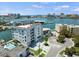 Aerial view of waterfront community, showcasing building and marina at 211 Dolphin Pt # 202, Clearwater Beach, FL 33767