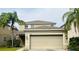 Tan two-story house with a two-car garage and landscaping at 2122 Richwood Pike Dr, Ruskin, FL 33570