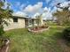 Landscaped backyard with a stone retaining wall at 218 6Th Sw Ave, Ruskin, FL 33570