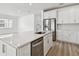 Kitchen featuring stainless appliances, white cabinetry and a kitchen island with a sink at 3584 Maple Bay Ln, Land O Lakes, FL 34638