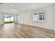 Bright living room with wood floors, recessed lighting, and a sliding door to the backyard at 3584 Maple Bay Ln, Land O Lakes, FL 34638