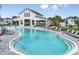 Community pool with ample seating, sun umbrellas, and a zero entry walk in feature for easy access at 3584 Maple Bay Ln, Land O Lakes, FL 34638