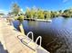 Community dock with a ladder leading to a tranquil lake at 5227 Dayton Ln, Port Charlotte, FL 33981