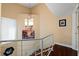 Hallway with a staircase featuring modern lighting and artwork creating an inviting transitional space with stylish design elements at 722 Pinellas Bayway S # 102, St Petersburg, FL 33715