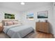 Light-filled bedroom with dresser and comfortable bed at 1009 Farragut N Dr, St Petersburg, FL 33710