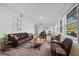 Sunlit living room featuring leather armchairs and sofa at 1009 Farragut N Dr, St Petersburg, FL 33710