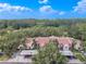 Aerial view of building showcasing the Spanish-style architecture and surrounding landscape at 3505 Tarpon Woods Blvd # K409, Palm Harbor, FL 34685