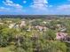 Aerial view of community with lush landscaping and lake at 3505 Tarpon Woods Blvd # K409, Palm Harbor, FL 34685