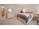 Spacious bedroom with plush carpeting and en-suite bathroom access at 3505 Tarpon Woods Blvd # K409, Palm Harbor, FL 34685