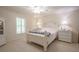 Bright bedroom with white furniture and plantation shutters at 3505 Tarpon Woods Blvd # K409, Palm Harbor, FL 34685