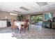 Clubhouse with a large table, chairs, and access to outdoor patio at 3505 Tarpon Woods Blvd # K409, Palm Harbor, FL 34685