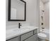 Bathroom featuring tiled shower and tub, light gray vanity and black hardware at 5479 Brussels Ter, Port Charlotte, FL 33981