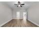 Spacious bedroom featuring a ceiling fan, wood-look floors, and multiple entryways at 5479 Brussels Ter, Port Charlotte, FL 33981