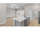 Bright, open-concept kitchen island features stainless steel dishwasher and sink with modern faucet at 5479 Brussels Ter, Port Charlotte, FL 33981